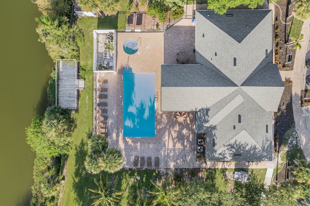 An aerial view of a house with a pool in the backyard.