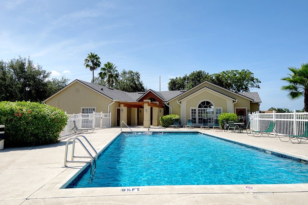 A swimming pool in front of a house.