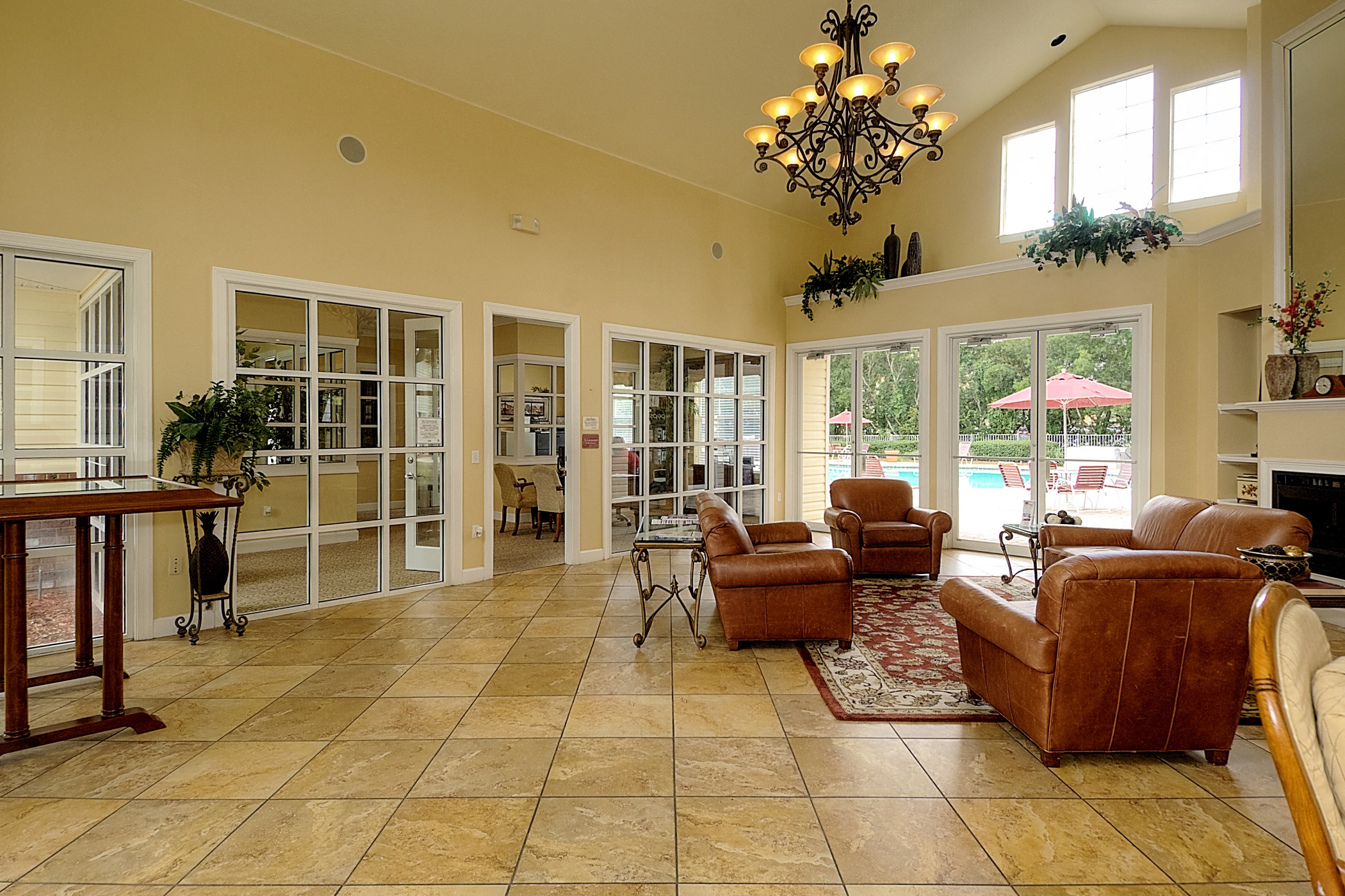 a living room with couches and chairs and a chandelier