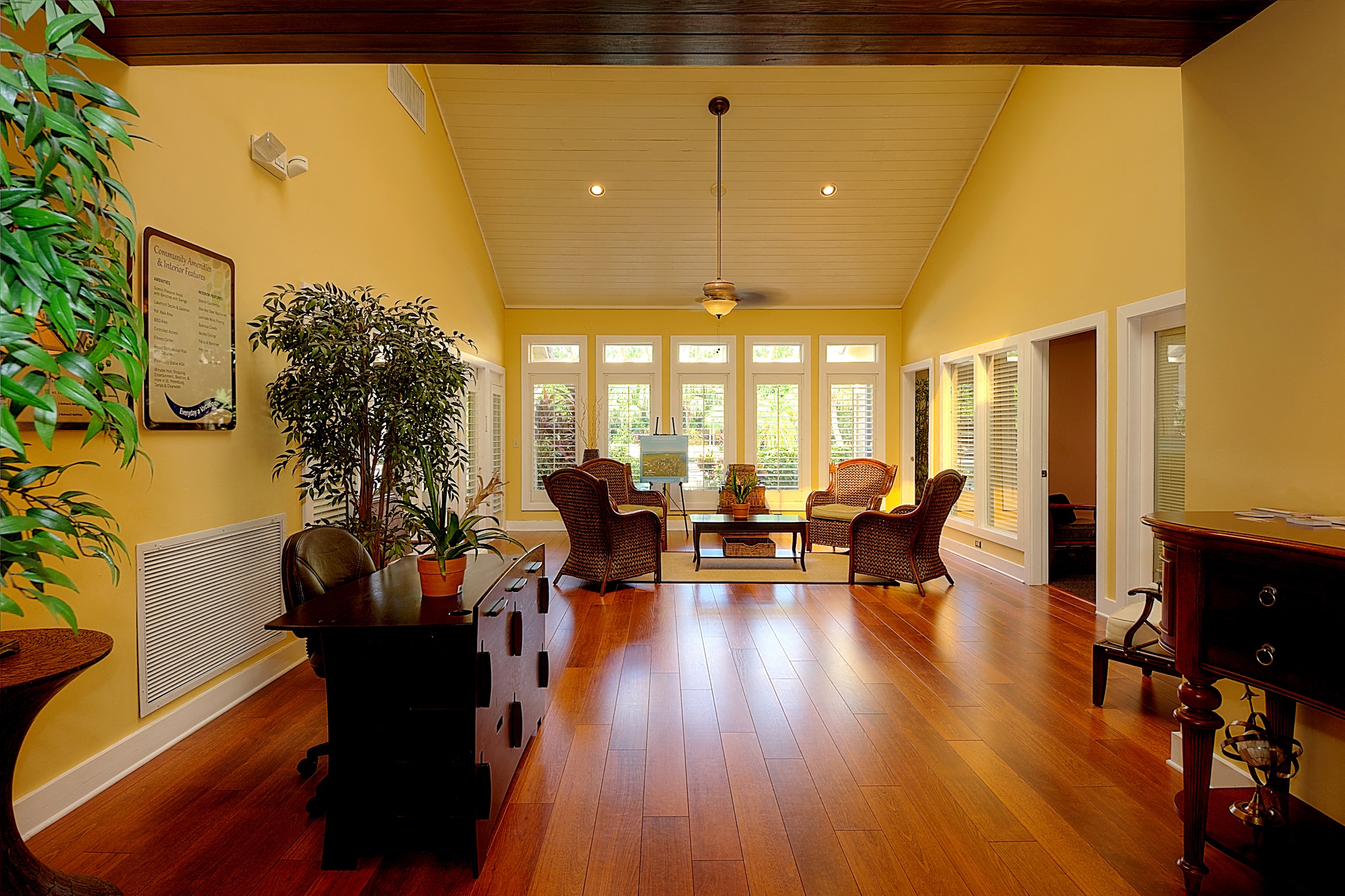 a living room with a hard wood floor and a table and chairs