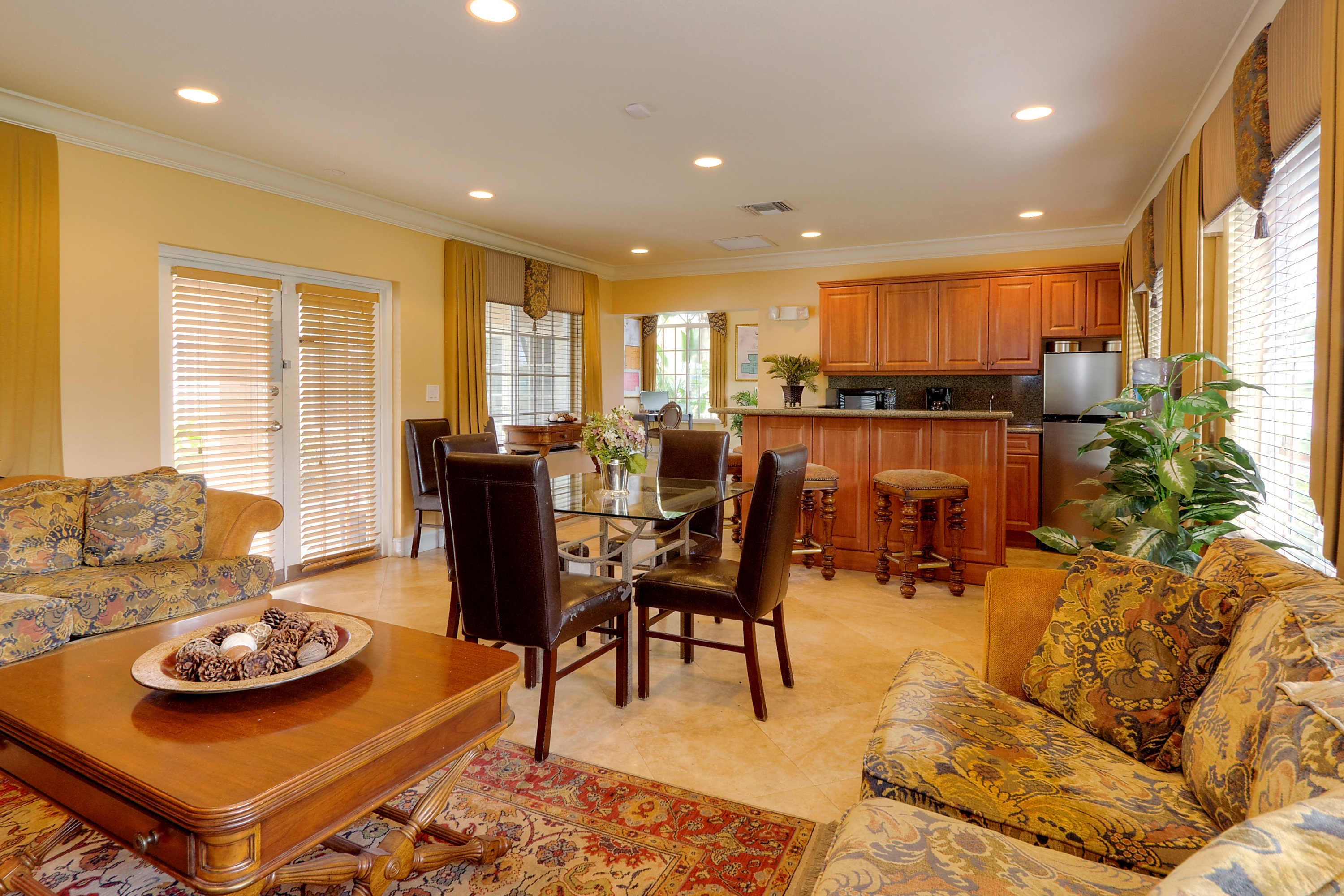 a living room and dining room with a table and chairs