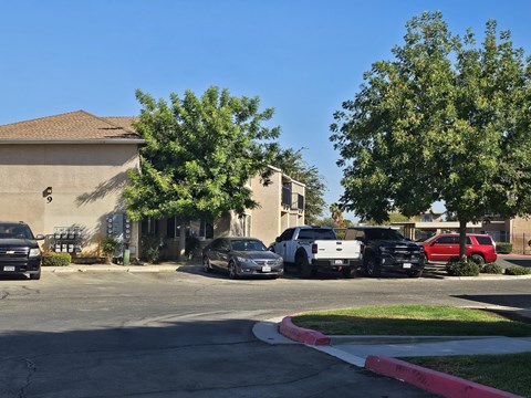 A black car is parked in front of a house.
