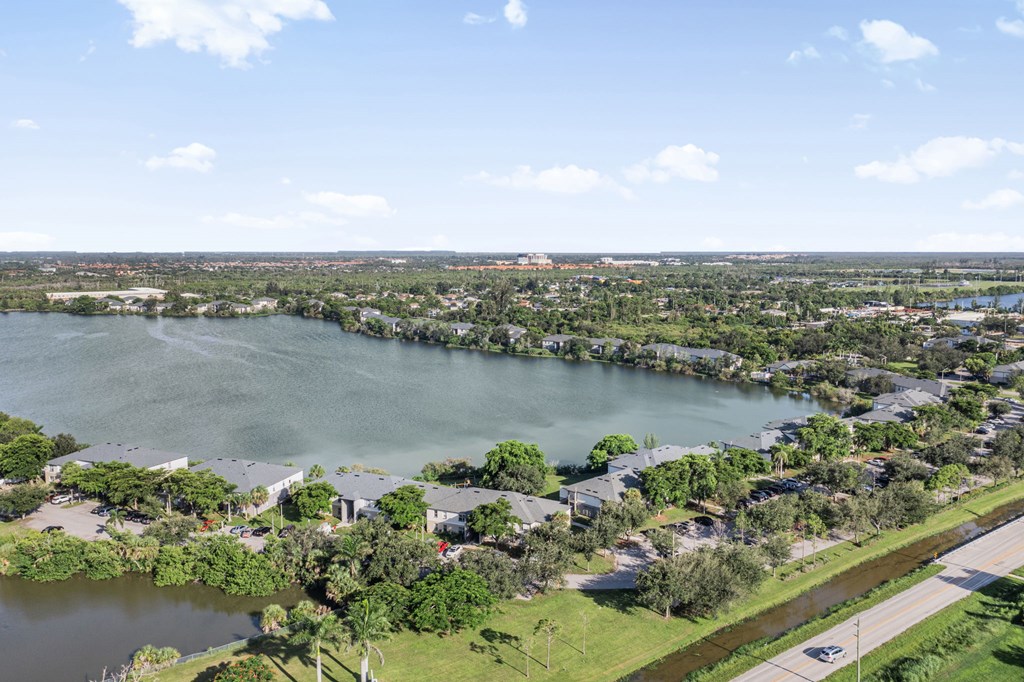 A large body of water surrounded by houses and trees.