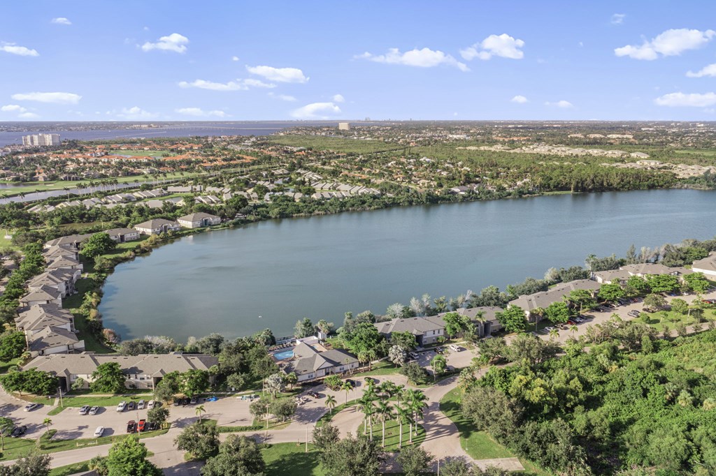 A large body of water surrounded by greenery and buildings.