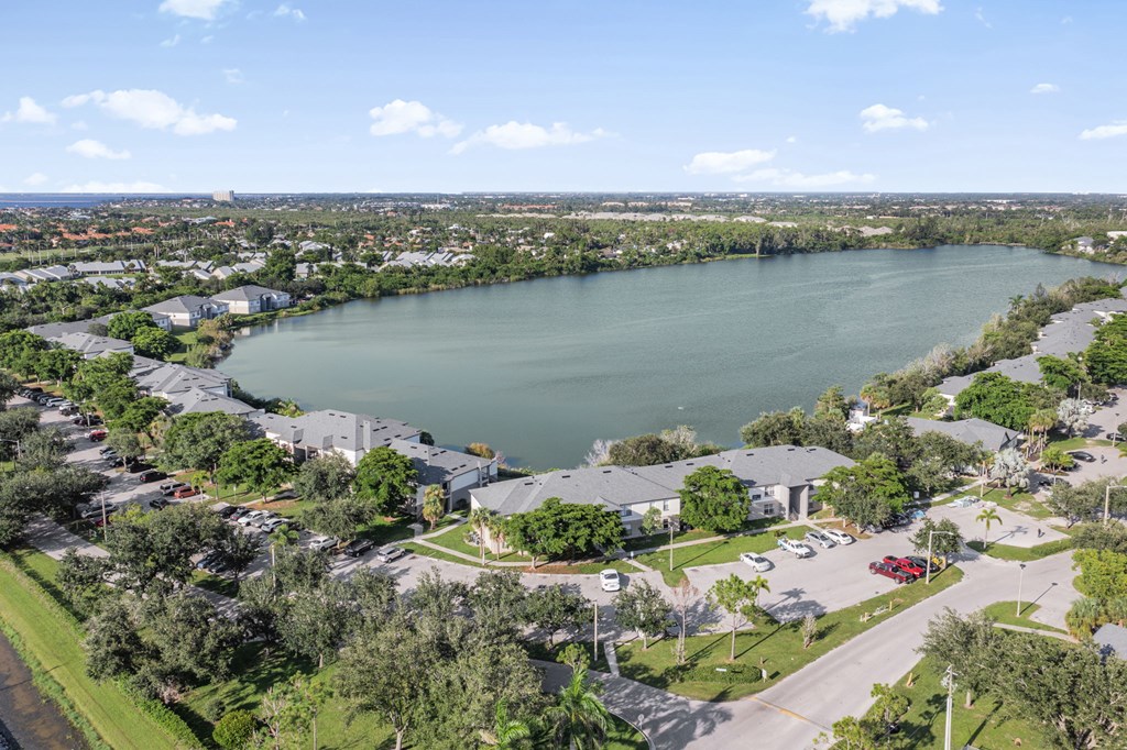 A large lake is surrounded by houses and trees.