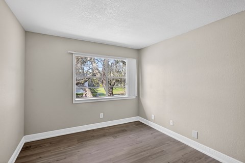 A room with a window and a picture on the wall. at Willow Brooke Apartments, Tampa, 33613