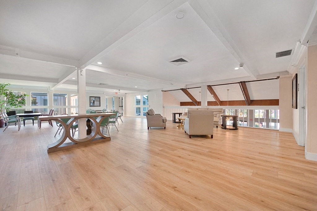 a large living room with hardwood floors and white walls at Citrus Heights Apartments, Citrus Heights, California