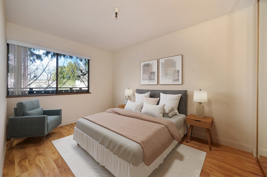 a bedroom with a large bed and a window