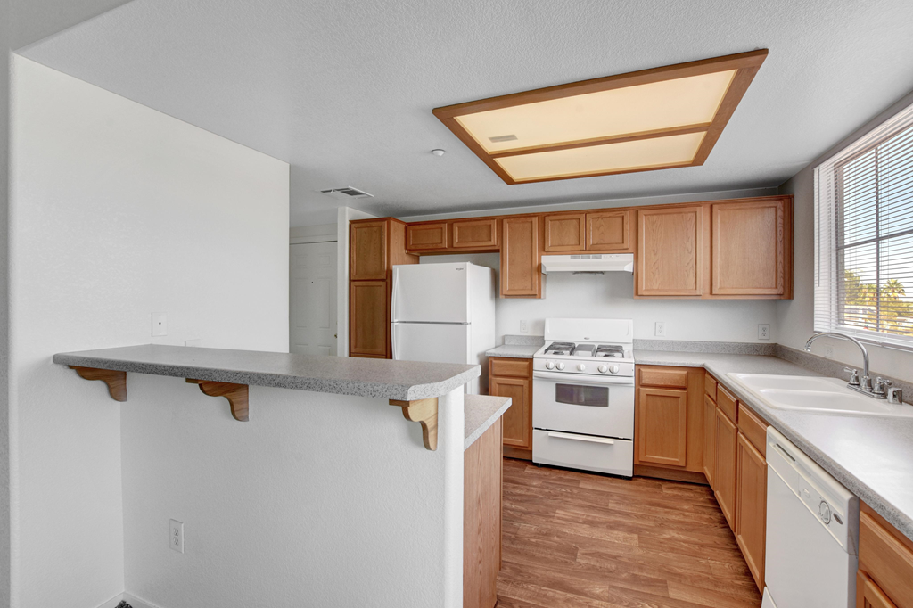 a kitchen with white appliances and wooden cabinets