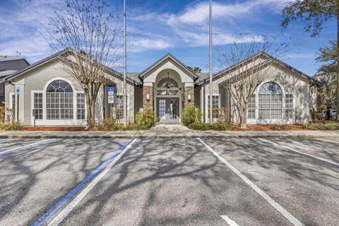 A large building with a parking lot in front of it.