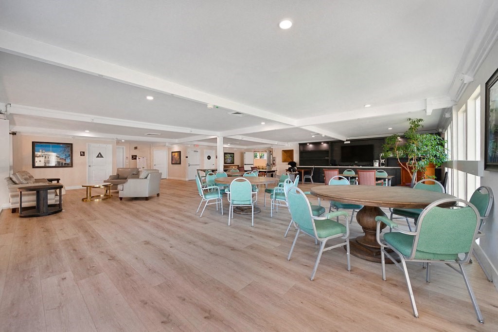 a resident clubhouse with tables and chairs at The Crest at Citrus Heights Apartments, Citrus Heights, 95621