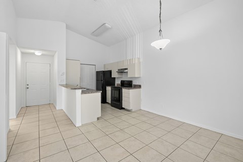 A kitchen area with a white counter and black appliances.