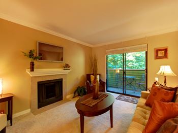 Living Room with balcony at Whispering Brook Apartments, Des Moines, WA