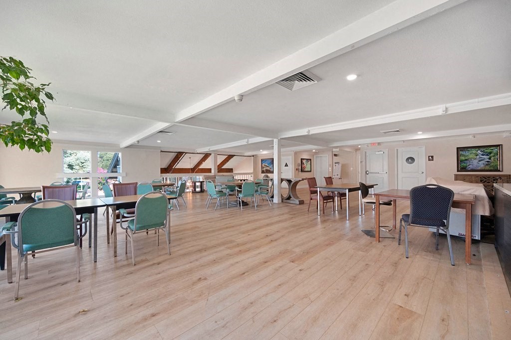 a large room with wooden floors and tables and chairs at Citrus Heights Apartments, Citrus Heights, CA,95621