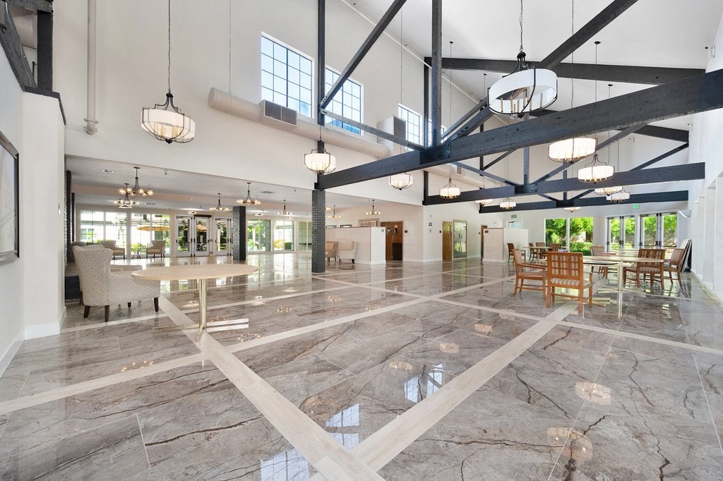a large open room with a marble floor and exposed beams