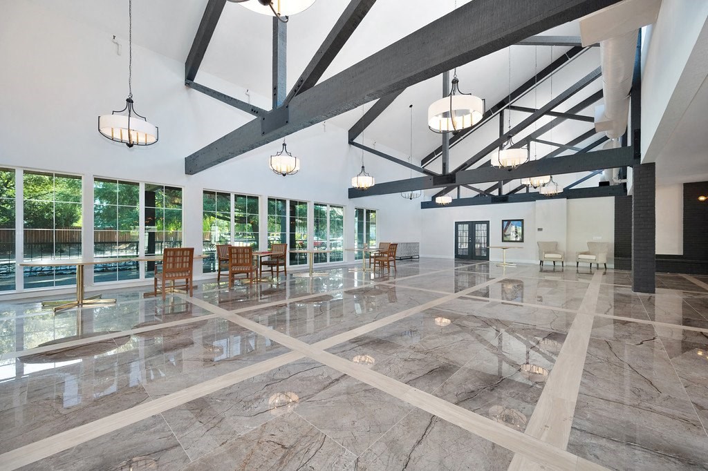a large room with large windows and a large marble floor