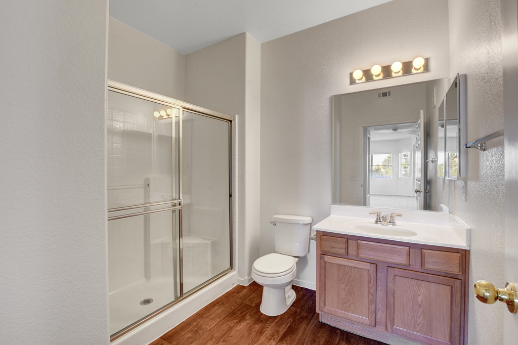 a bathroom with a shower toilet and sink