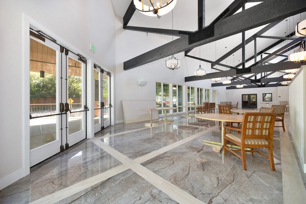 a large room with a table and chairs