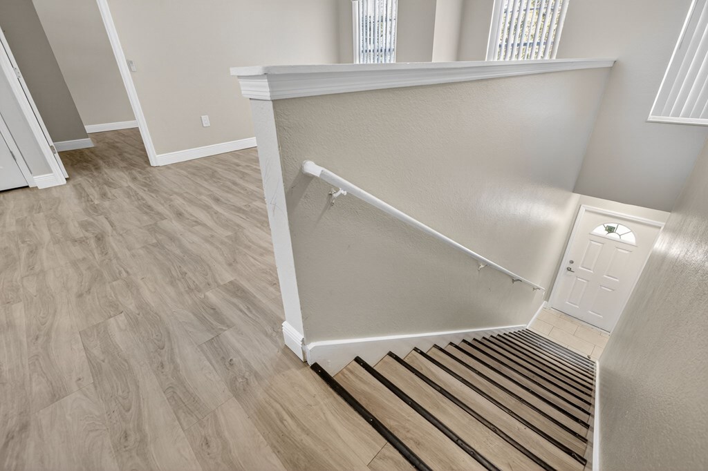 A stairway with a white railing and wooden steps.