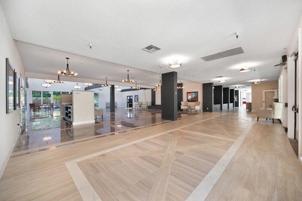a large lobby with hardwood floors and white walls