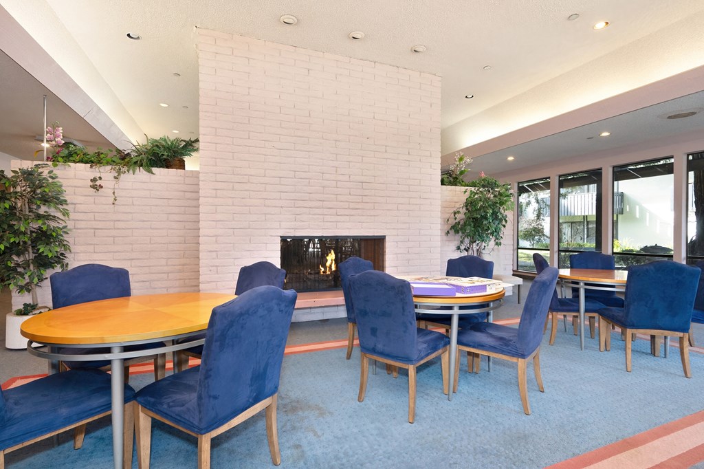 a dining room with a table and chairs in front of a fireplace