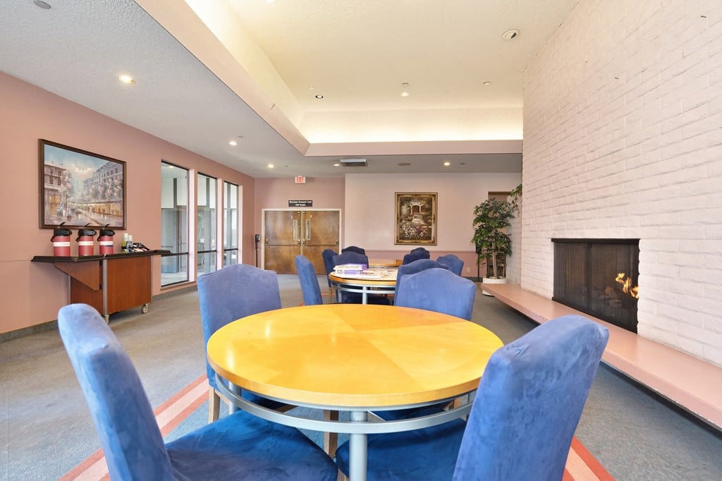 a dining room with a table and chairs and a fireplace