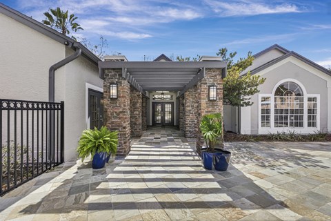 Covered entry courtyard with stone columns at The Ivy at Gatehouse Apartments, Orlando, 32807
