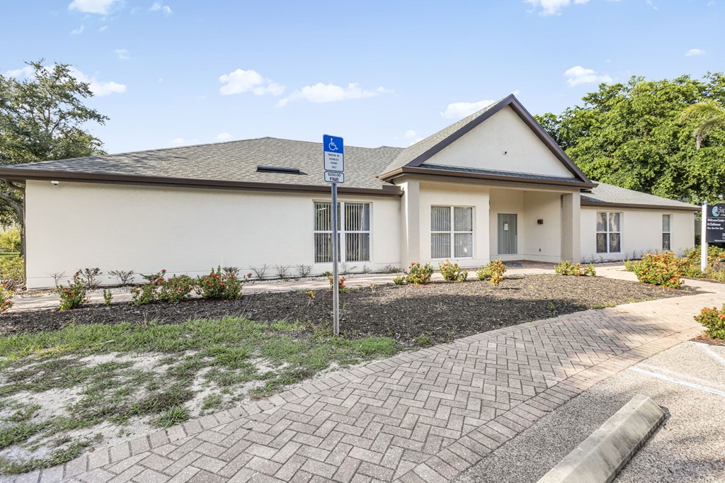 A house with a driveway and a parking sign in front.