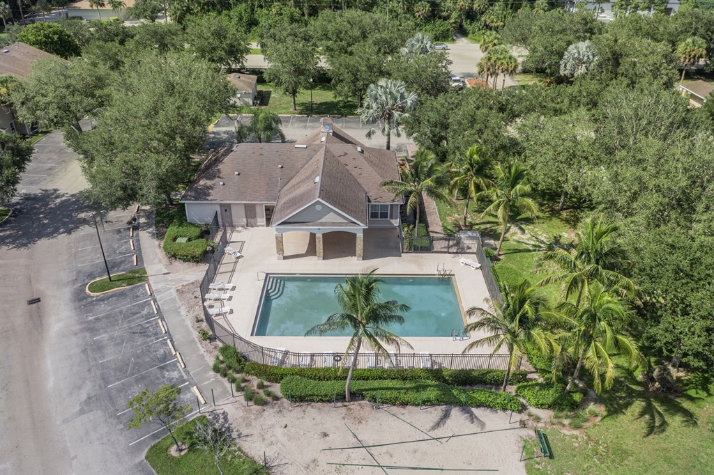 A house with a pool surrounded by trees.