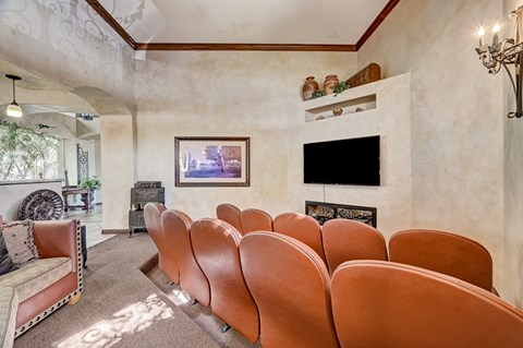 A room with a row of chairs and a fireplace.