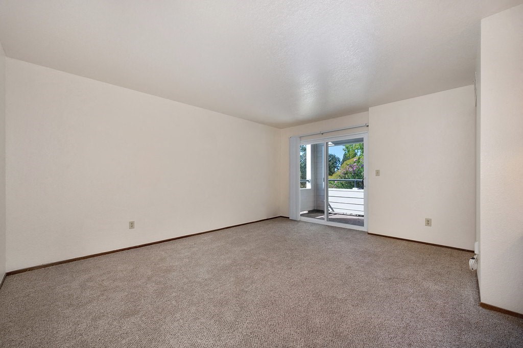 a bedroom with white walls and carpet