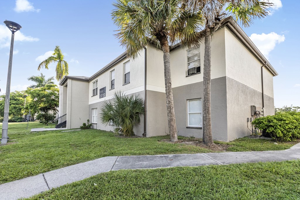 A building with a palm tree in front of it.