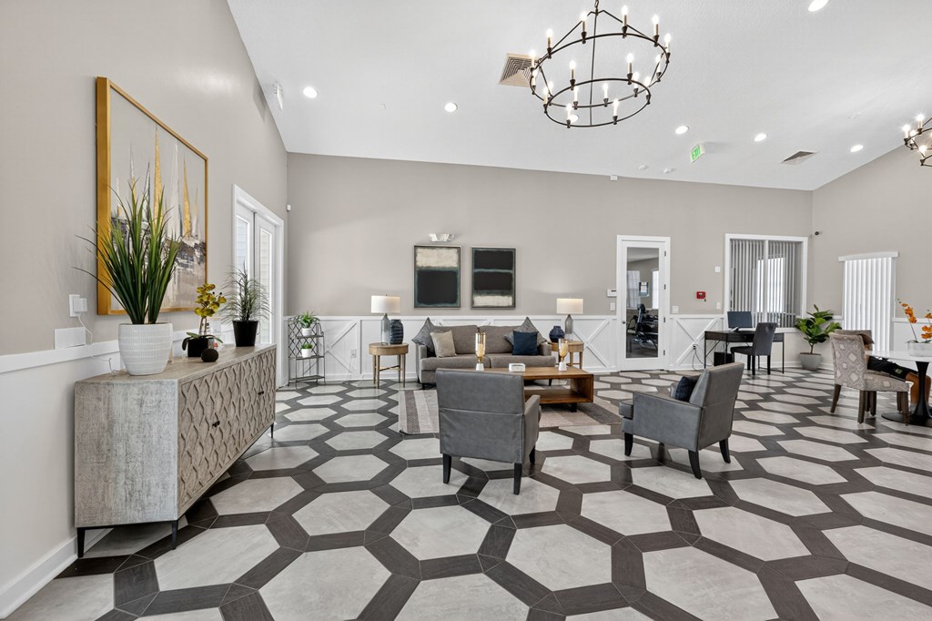 A spacious living room with a grey and white patterned floor.