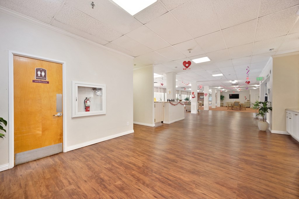 a hallway with wood floors and white walls and wooden doors