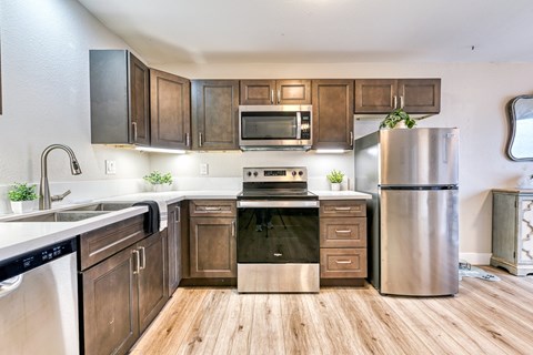 A modern kitchen with wooden cabinets and stainless steel appliances.