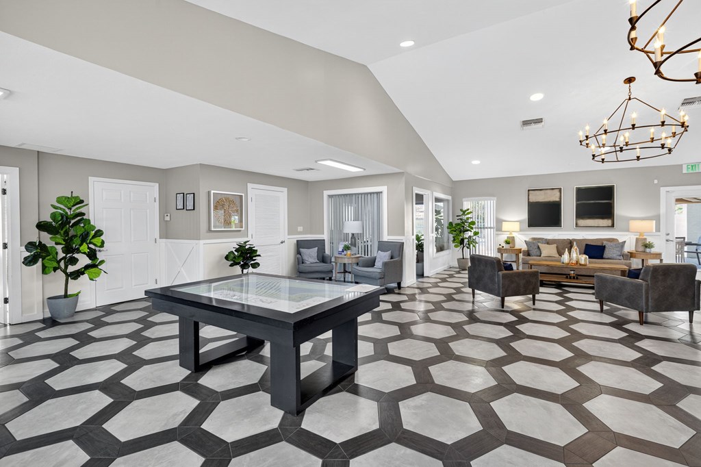 A spacious living room with a large table and chairs.