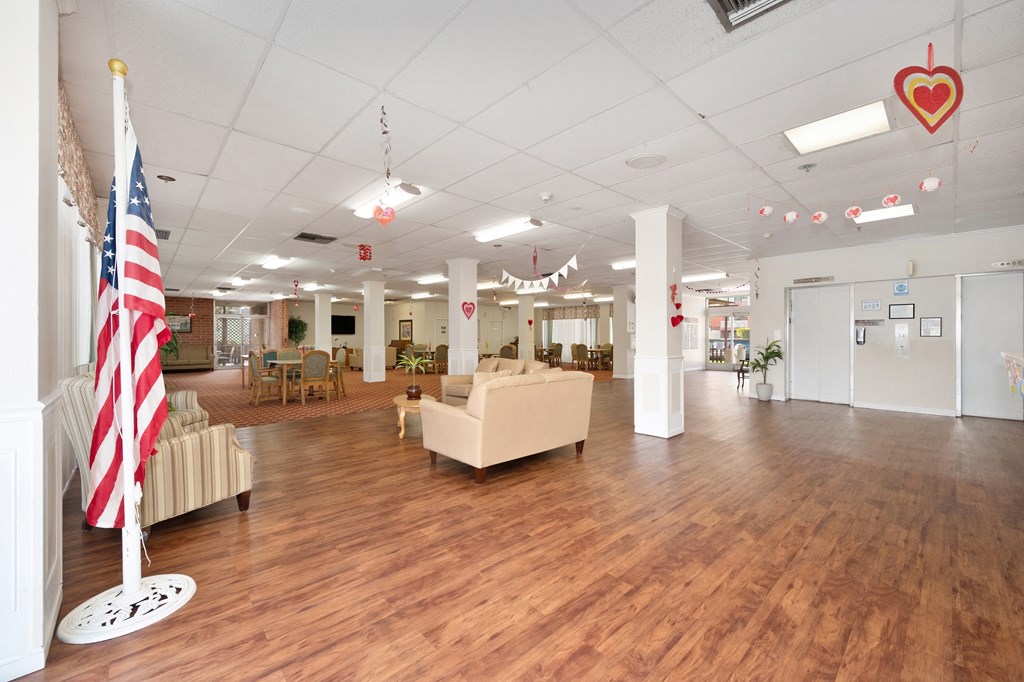 a lobby with couches and a flag in the center of the room