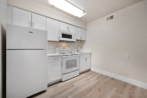 the preserve at ballantyne commons apartment kitchen with white cabinets and appliances