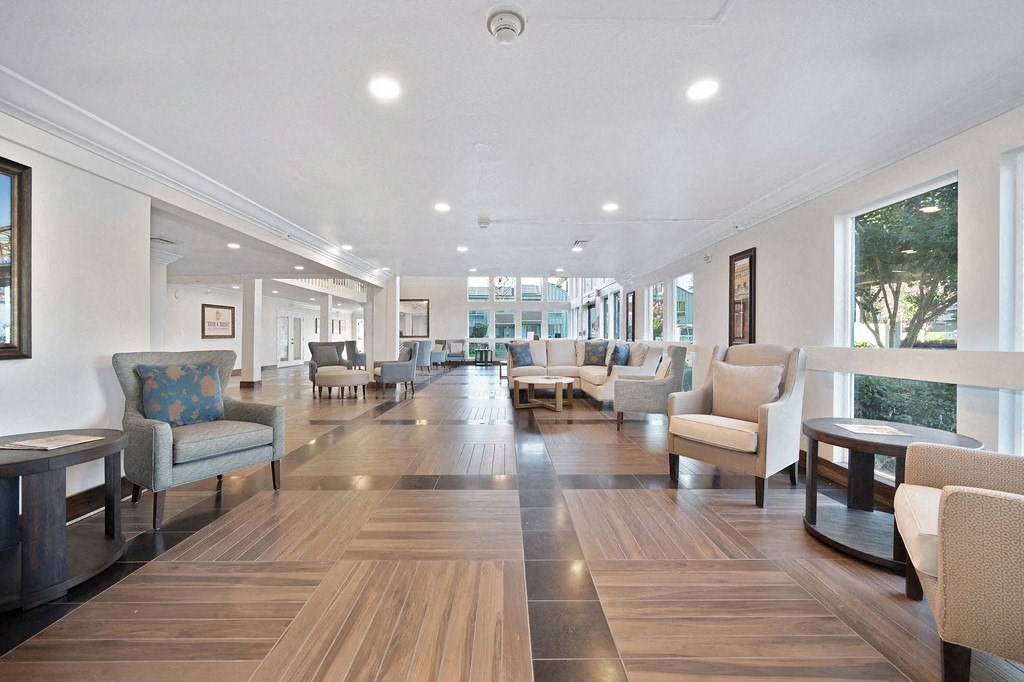 a lobby with chairs and couches at The Crest at Citrus Heights, California