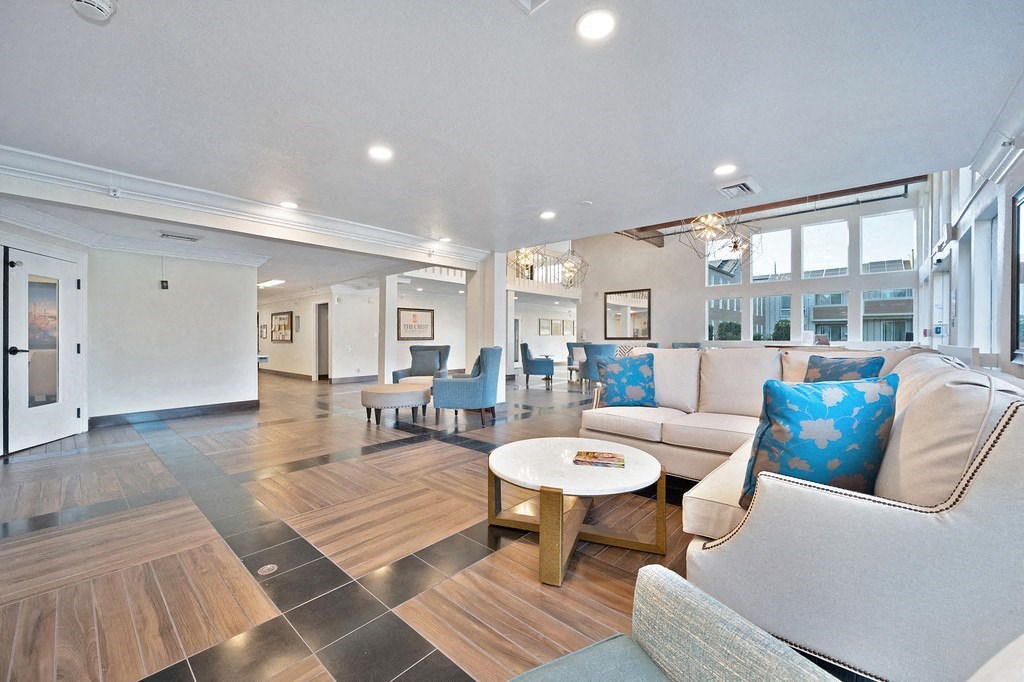 a resident clubhouse with couches chairs and a coffee table at Citrus Heights Apartments, Citrus Heights, CA