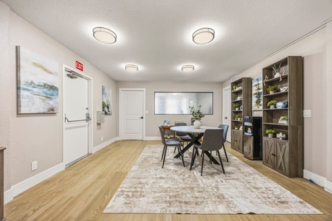 A dining room with a table and chairs.