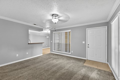A room with a white ceiling fan and a white door.