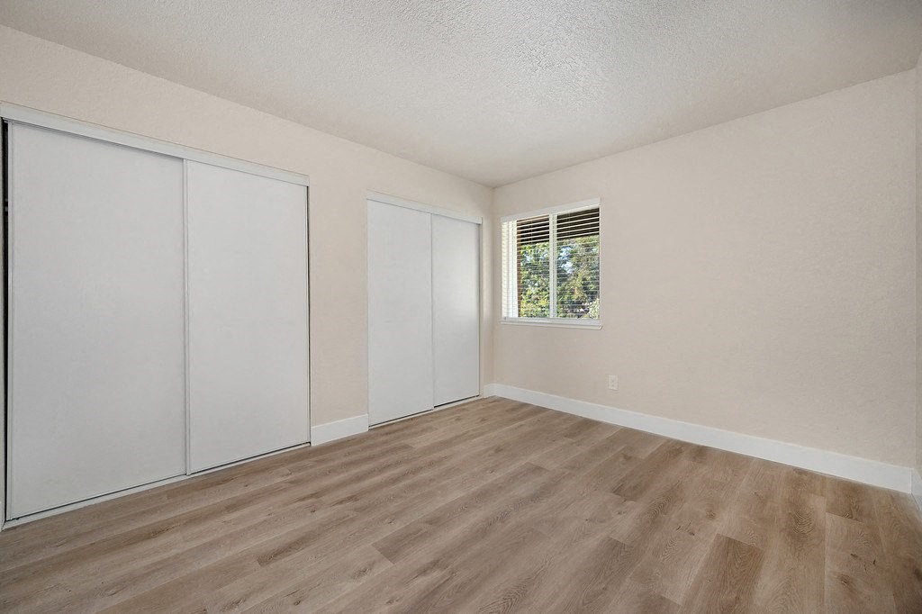 a bedroom with two closets and a window
