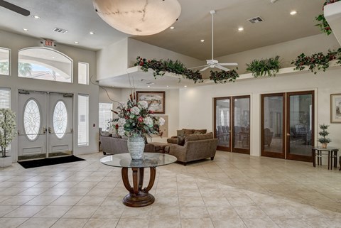 A living room with a glass table and a couch.