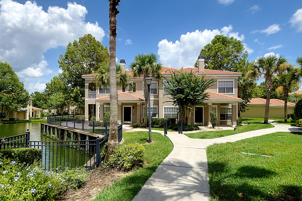 a large house with a dock on a body of water