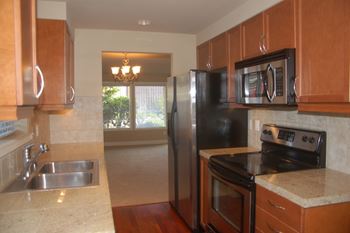 Kitchen with appliances at Village at The Pointe Apartments, Washington,98407