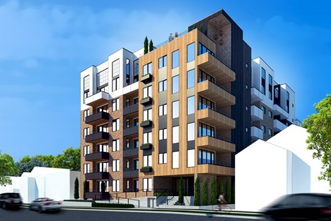 A modern multi-story apartment building with balconies and a mix of brick and panel facades.