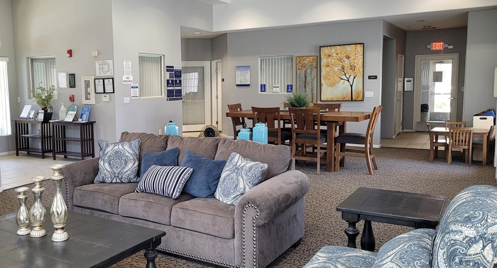 A living room with a grey couch and a coffee table.