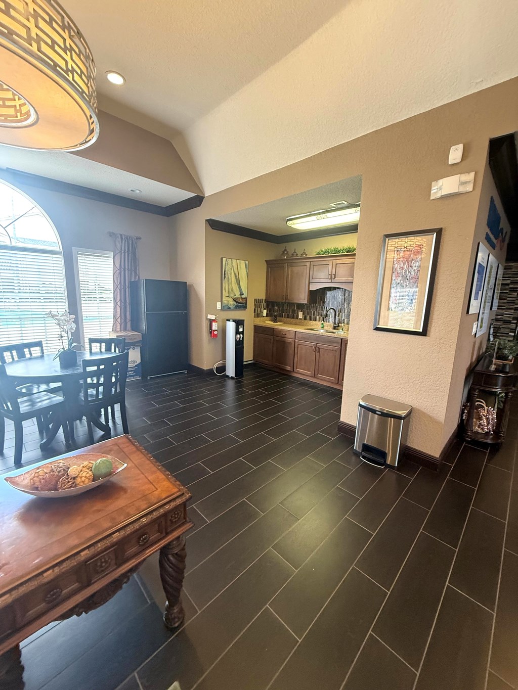 A kitchen with a table and chairs in the foreground.