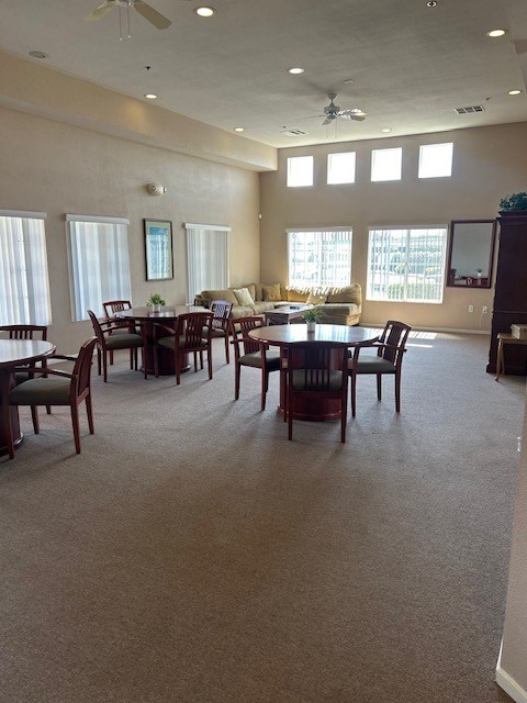 A spacious room with a dining table and chairs.